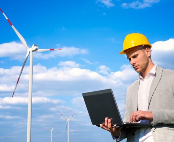 [fpdl.in]_engineer-working-his-laptop-front-wind-generators_342744-1049_medium